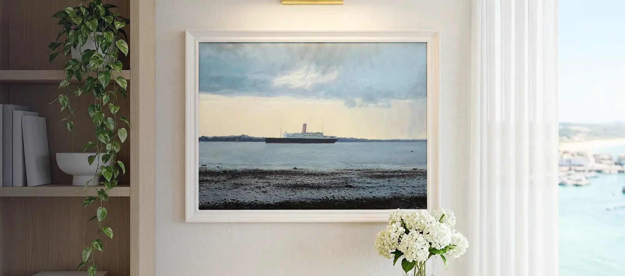 Framed painting of RMSP Asturias hanging on a white wall above a light wood console table decorated with white hydrangeas.