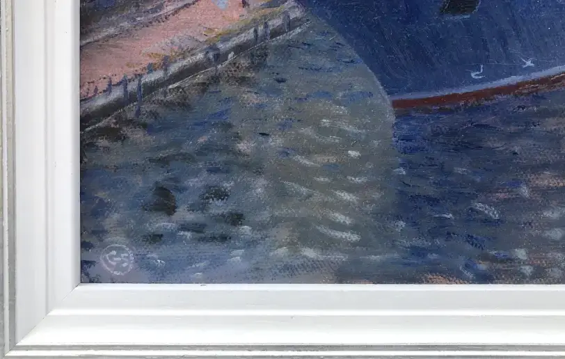 Close up of the white wood picture frame and the artist's signature painted in the bottom corner of the canvas.