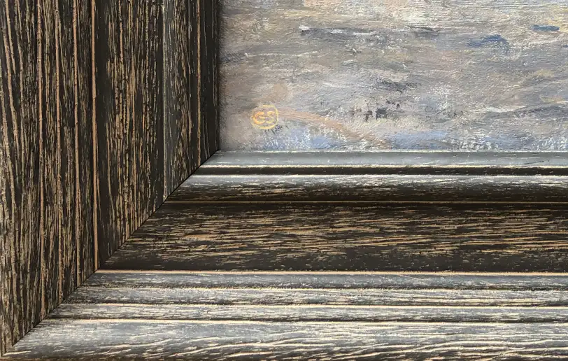 Close up of the dark, textured wooden frame and inner white linen slip, contrasting with the painted ocean waves.