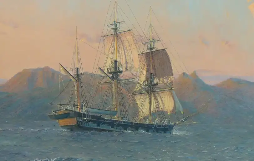 Close up of Charles Darwin's ship, HMS Beagle, under sail with its reflection catching the early morning light on the water.