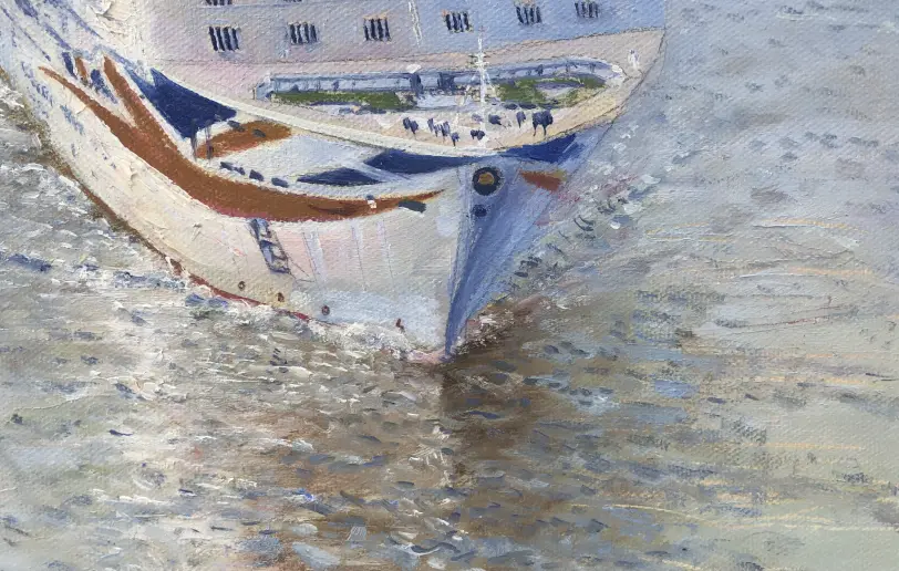 Close up of the bow of Britannia cutting through the water, showing the Union Jack painted on the hull.