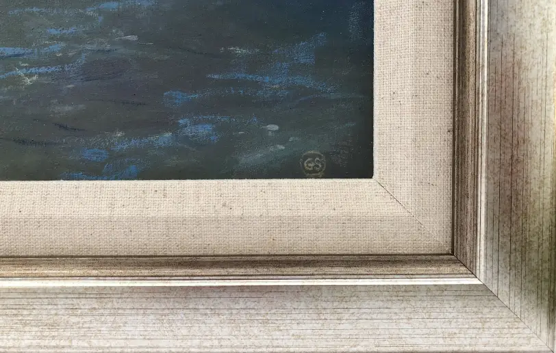 Close up of the champagne gold picture frame, the inner white linen slip, and the artist's initials painted over the choppy water.