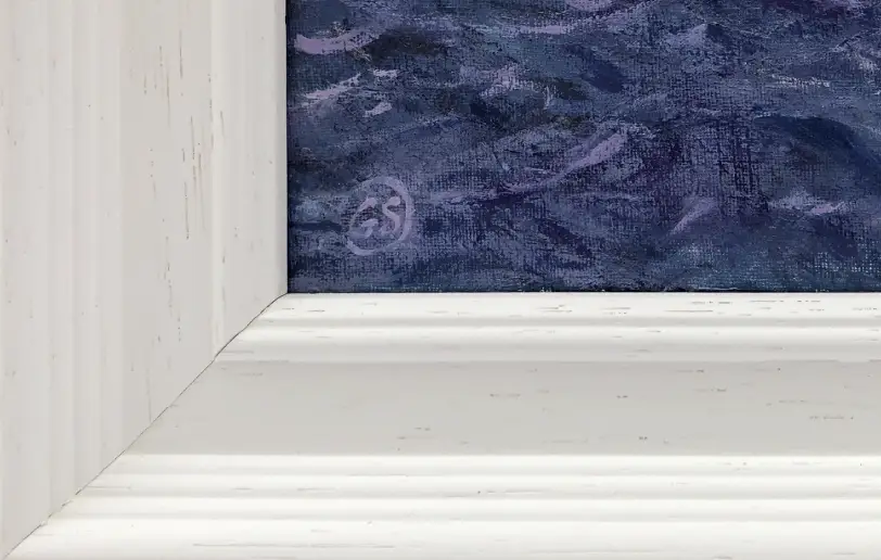 Close up of the white wood picture frame and the textured oil paint of the deep sea.