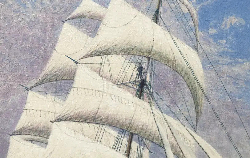 Close up of the massive white sails billowing in the wind against the sky.