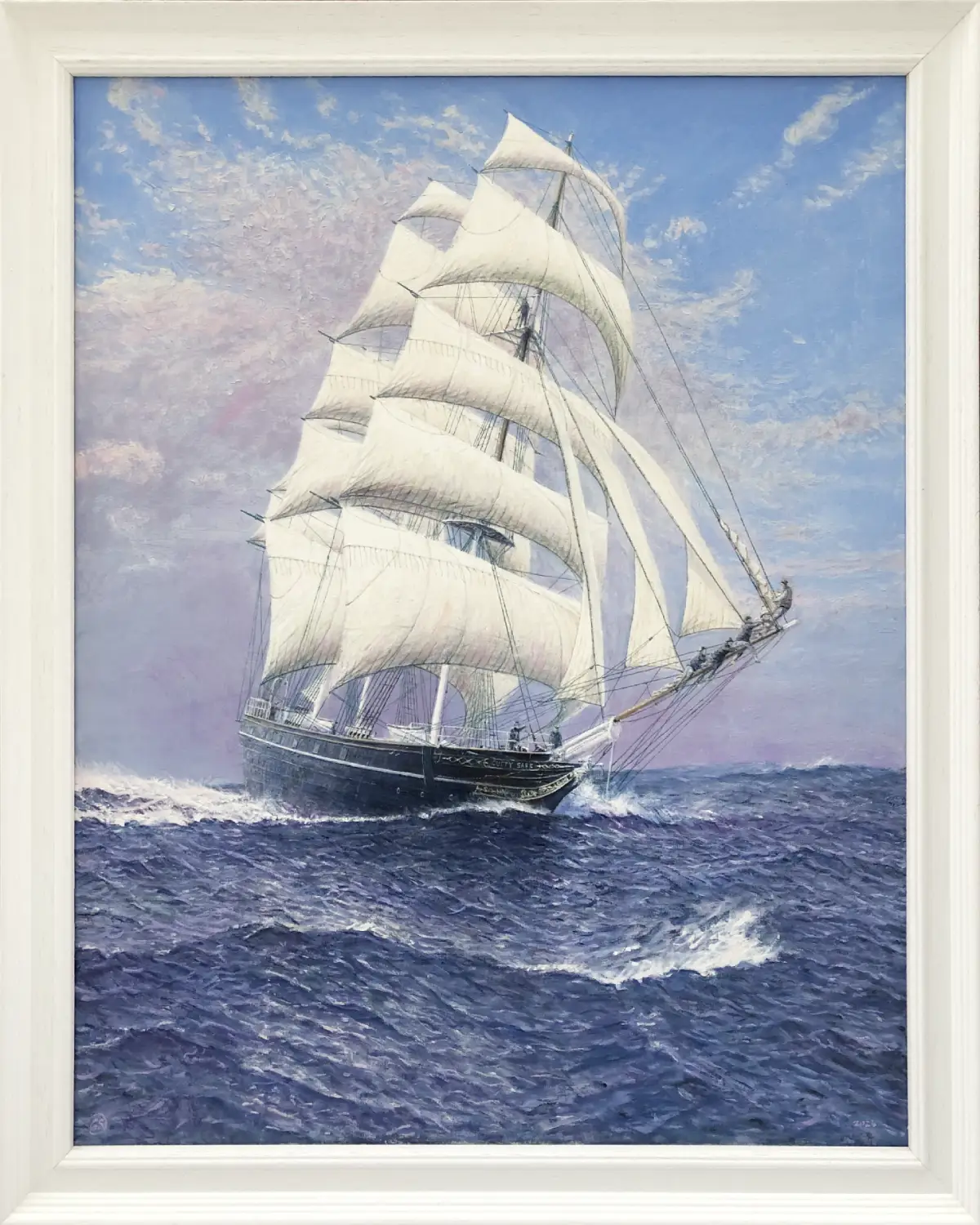 Oil painting in a white wood frame showing the historic clipper ship Cutty Sark cutting powerfully through deep blue, choppy waves under a dynamic, cloudy sky.