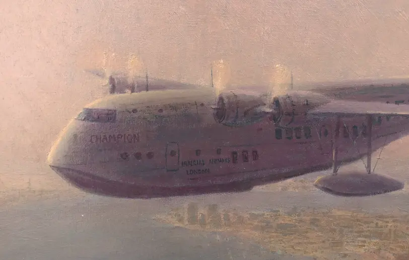 Close up of the Short Empire flying boat with its four engines and registration markings, flying low over the densely packed old town architecture.