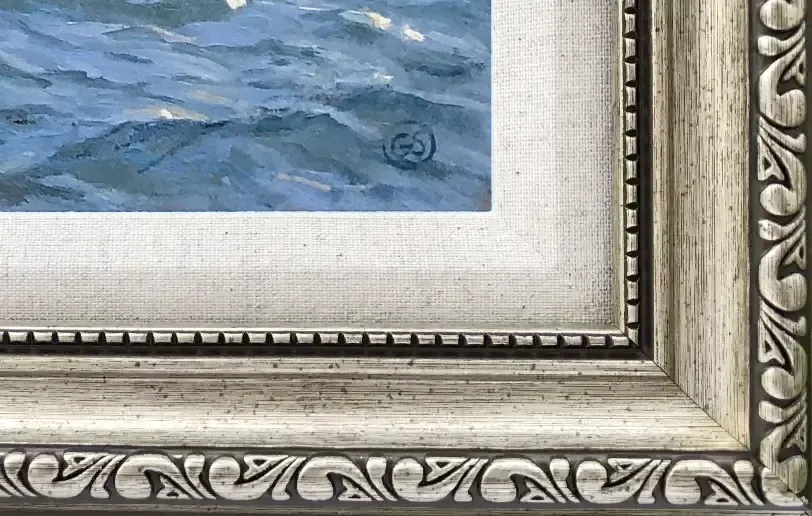 Close-up macro of the champagne gold picture frame moulding and textured linen slip.