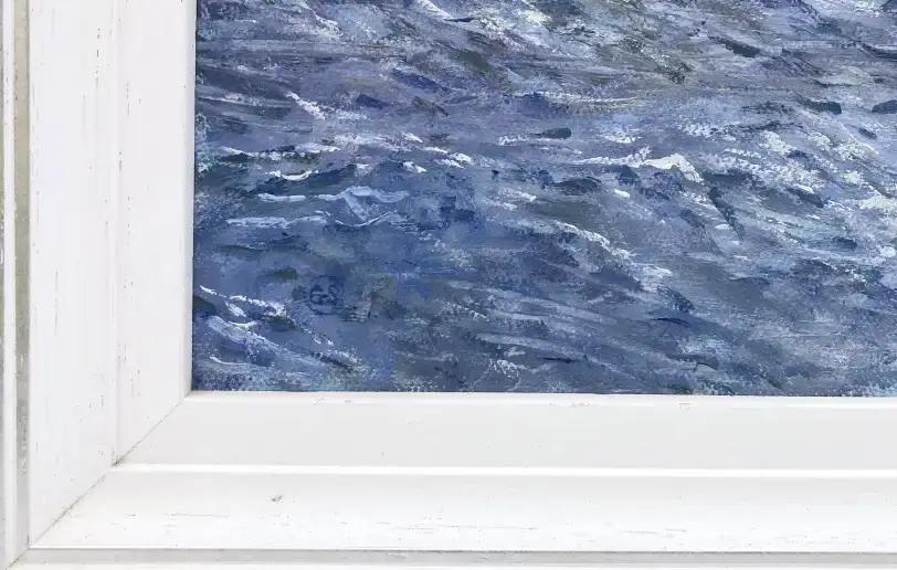 Close up of the white wood picture frame and the textured blue oil paint of the sea.