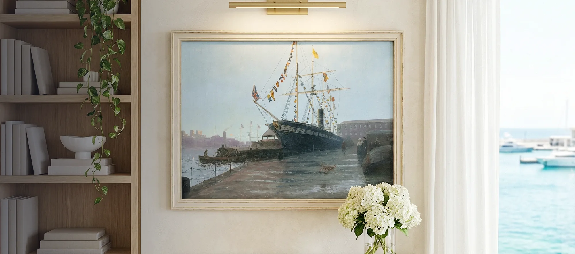 Framed painting of the SS Great Britain hanging on a white wall above a light wooden table decorated with white hydrangeas, flanked by a modern bookcase.