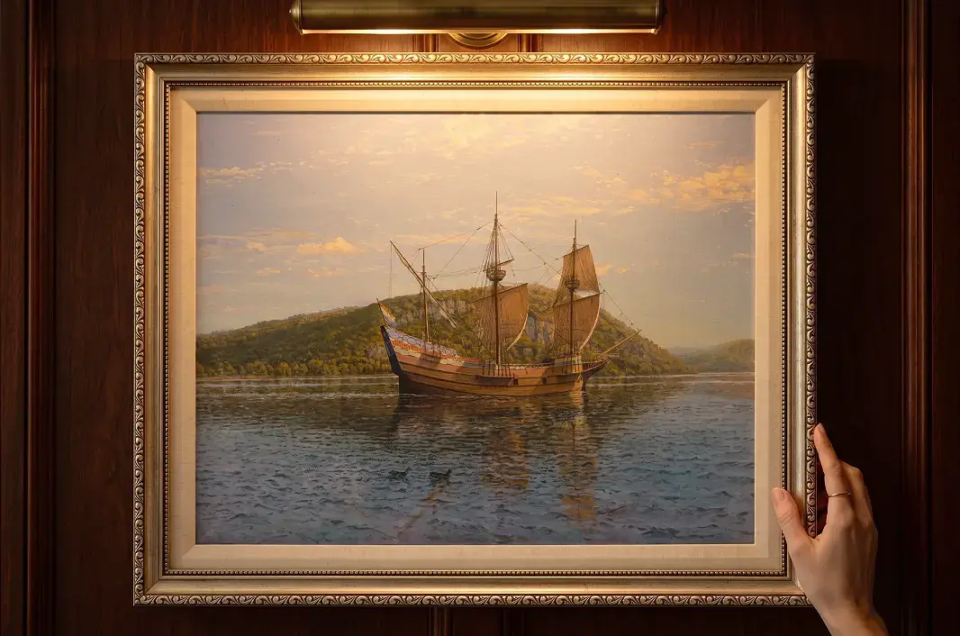 The framed Half Moon historical marine painting mounted on a rich wooden panelled wall illuminated under a warm picture light.