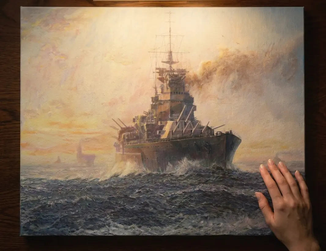 The unframed painted canvas held flat against a dark wooden table.