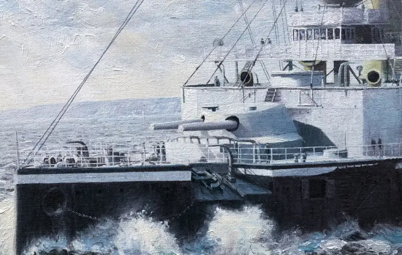Close up of the bow of HMS Majestic showing her forward guns and dark painted hull plunging through the waves.