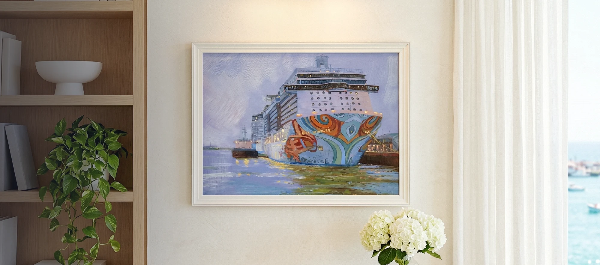 Framed painting of the cruise ship Norwegian Getaway hanging on a white wall above a light wood console table decorated with white hydrangeas.