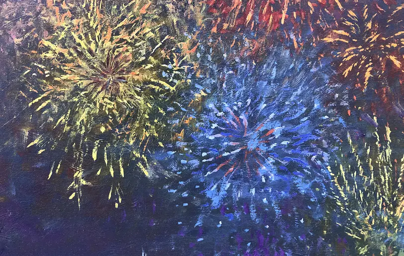 Close up of the vibrant blue and gold fireworks bursting in the night sky.