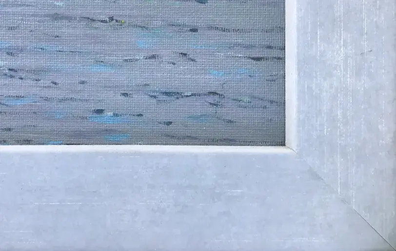 Close up of the pale grey wooden picture frame, showing the textured oil paint of the calm ocean water.