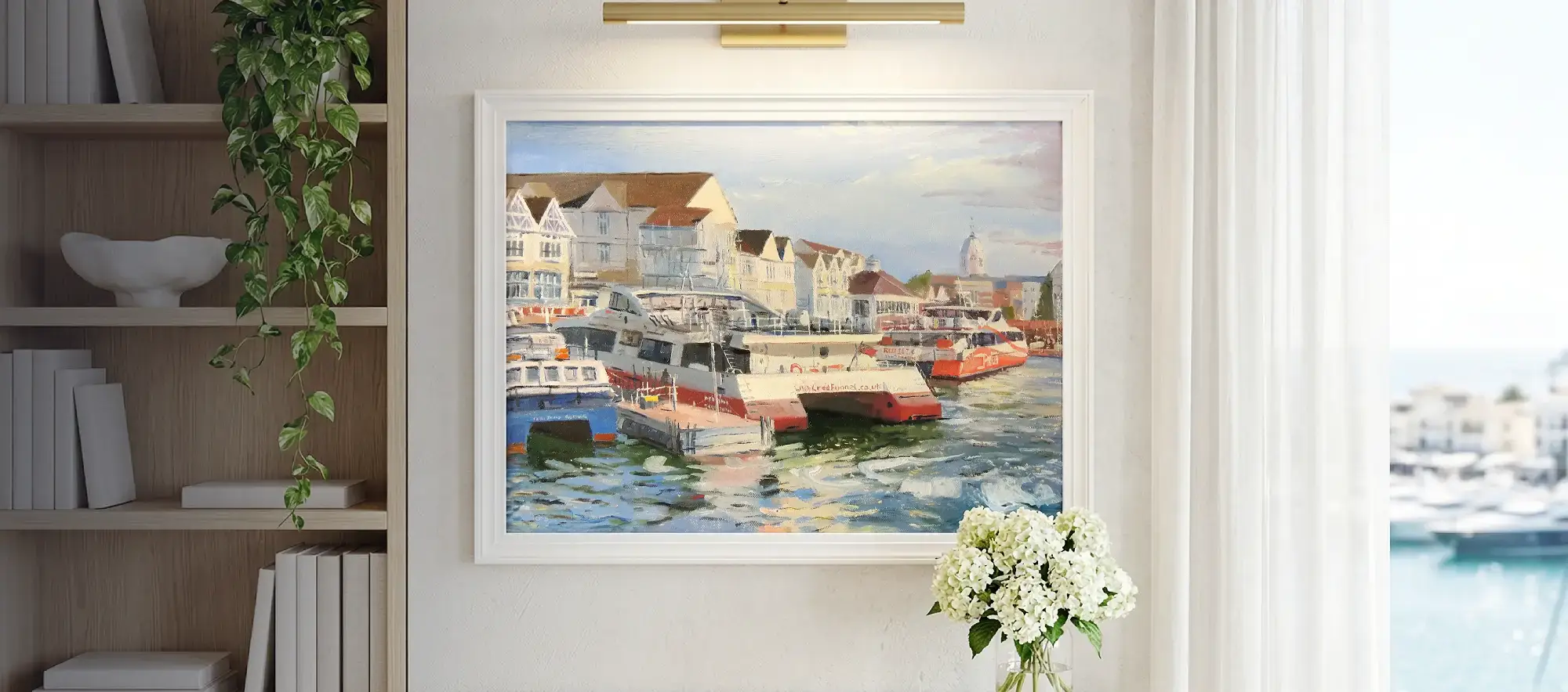 Framed plein air painting of Town Quay hanging on a white wall above a light wood console table decorated with white hydrangeas.