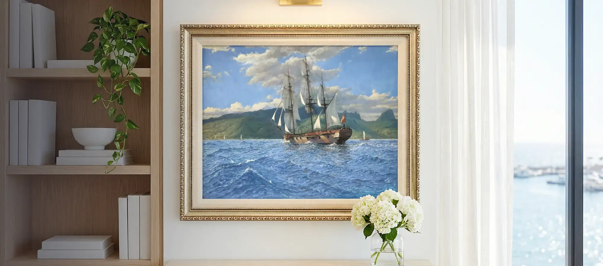 Framed painting of HMS Resolution hanging on a bright white wall above a wooden console table adorned with a vase of white hydrangeas. A bookcase and window are visible on the sides.