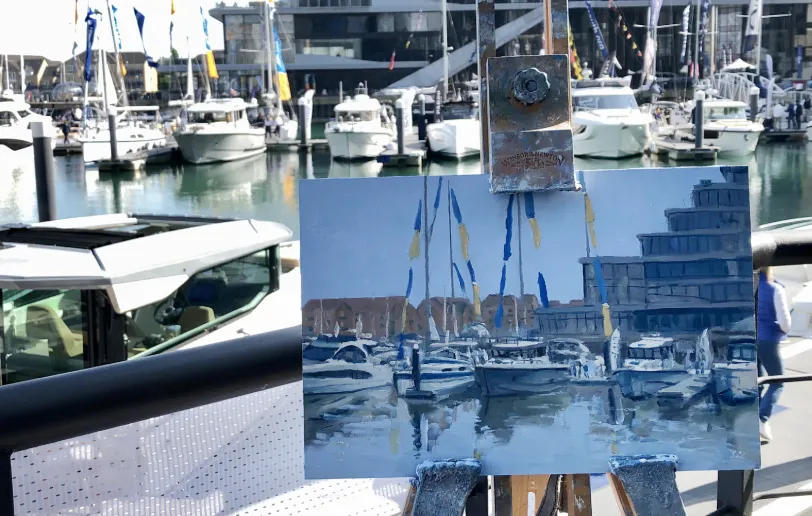Close up of the center of the painting showing the moored boats and reflections in the water.