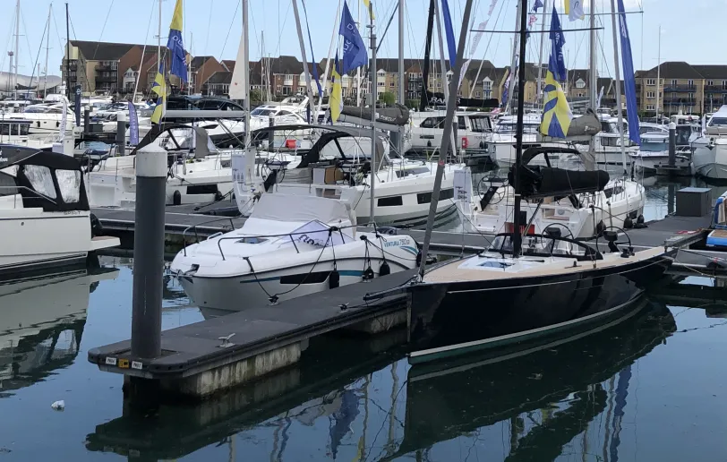 Close-up of white yachts and pontoons on the left side of the marina.