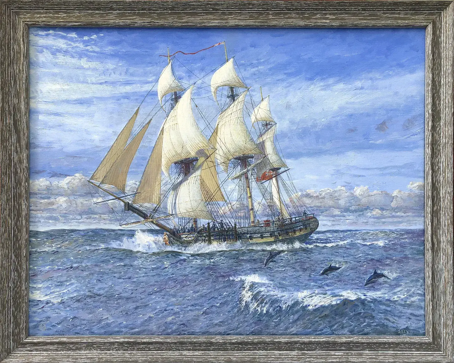 Oil painting in a distressed grey wood frame showing the three-masted ship HMS Sphinx under full sail on choppy blue seas. A pod of dolphins leaps through the waves in the foreground under a bright, dynamic sky.