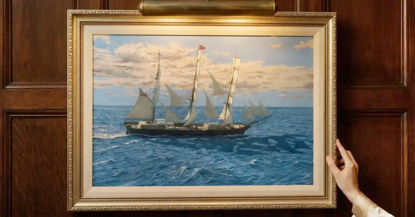 The framed painting of Titania hung in a sophisticated room with dark wood wall paneling, illuminated by a brass picture light above it. Two hands are seen gently adjusting the bottom right corner of the frame.