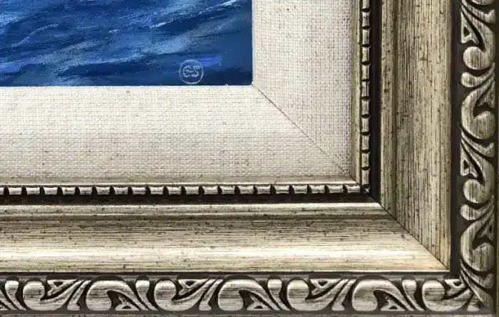 Close up of the lower right corner of the ornate Champagne gold picture frame, showing the inner linen slip, gold beading, and the artist's GS signature on the canvas.