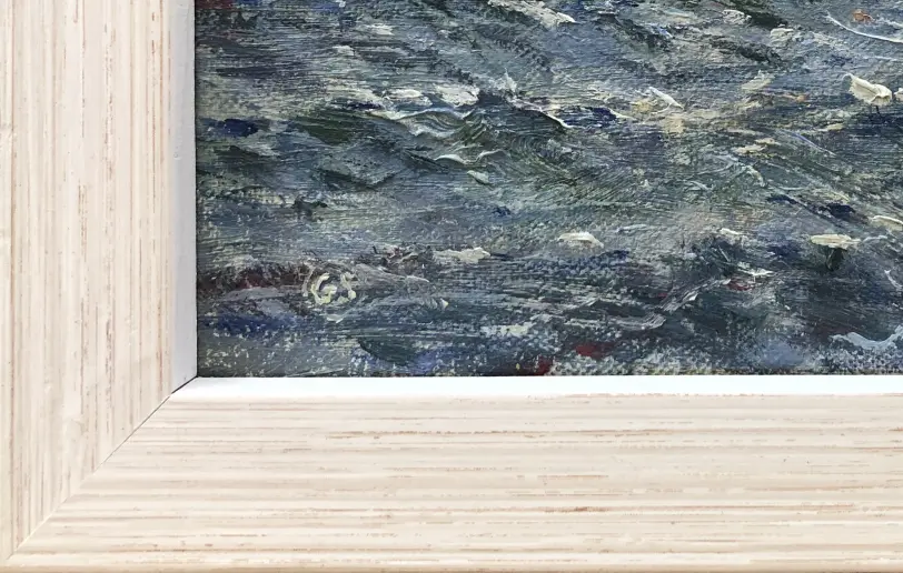 Close up of the light wood picture frame and the textured oil paint of the choppy sea.
