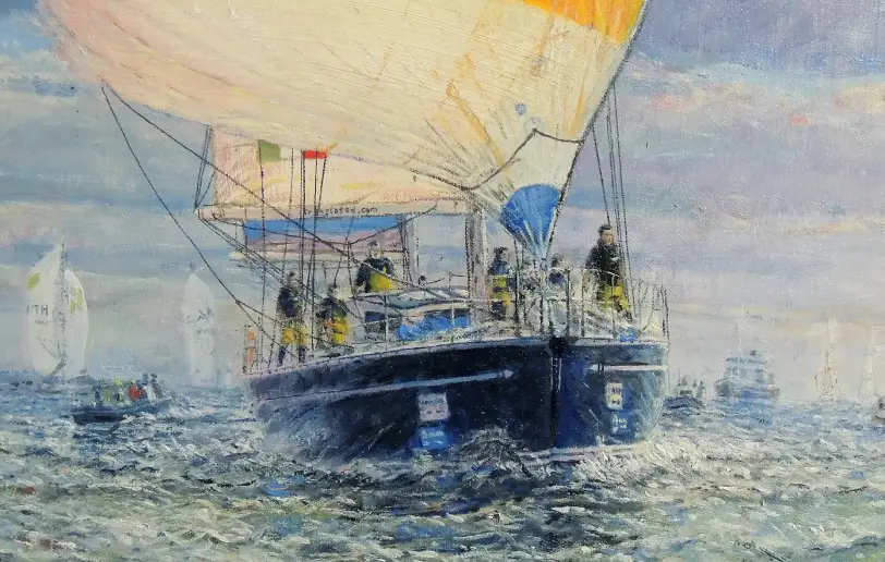 Close up of the yacht Translated 9 with its vibrant striped spinnaker and crew visible on deck.