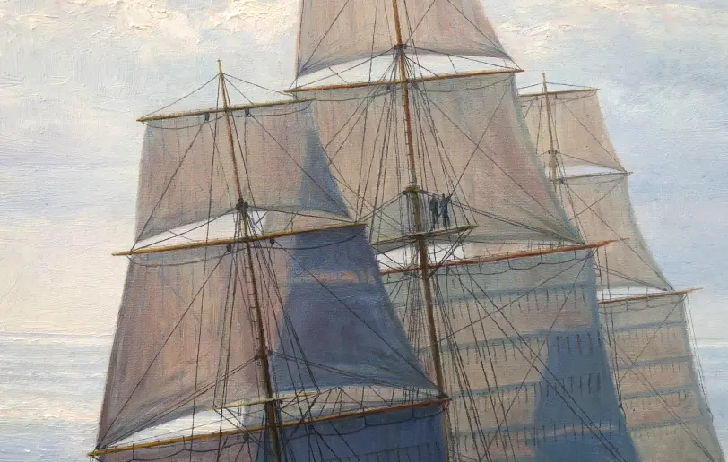 Close up of the ship's towering masts and large square sails glowing as they are backlit by the sun.